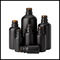Μαύρη παγωμένη καλλυντική συσκευασία μπουκαλιών γυαλιού ουσιαστικού πετρελαίου χρώματος γύρω από τη μορφή προμηθευτής